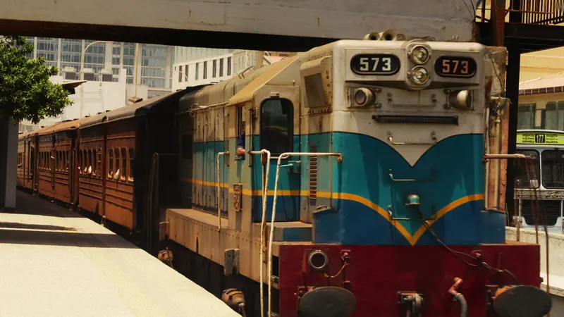 A blue and red train at a Colombo platform